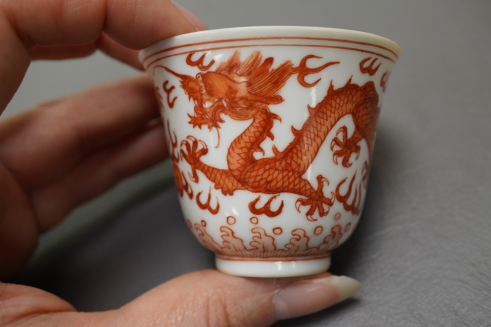 A pair of Chinese iron red ‘dragon’ cups, Guangxu six character mark and probably of the period (1875-1908)